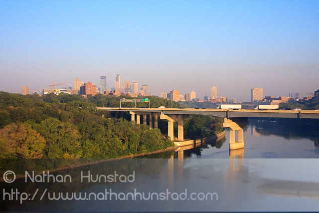 Downtown Minneapolis during rush hour from the Franklin Avenue Bridge. The Interstate 94 bridge across the river can be seen.